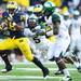 Michigan running back Fitzgerald Toussaint attempts to run the ball past cornerback Johnny Adams and safety Isaiah Lewis during the second quarter at Michigan Stadium on Saturday afternoon. Melanie Maxwell I AnnArbor.com
